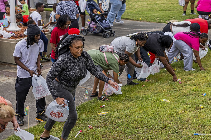 Adult participants of all ages spread out across the lawn, eagerly gathering colorful eggs and treats during the community-wide Easter egg hunt. (Pine Bluff Commercial/I.C. Murrell)