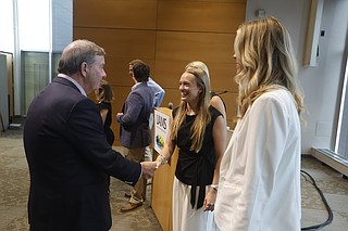 Dr. C. Lowry Barnes (left), chancellor of University of Arkansas for Medical Science, congratulates Chloe King (center), a pharmacy student from Conway, and Grace Ann Shelnut (right), a dietetics student from Benton, after an announcement of a $7 million donation from the Windgate Foundation to fund scholarships on Monday, June 8, 2028, at UAMS in Little Rock. King and Shelnut are two of the five scholarship recipients announced on Monday. .(Arkansas Democrat-Gazette/Thomas Metthe)