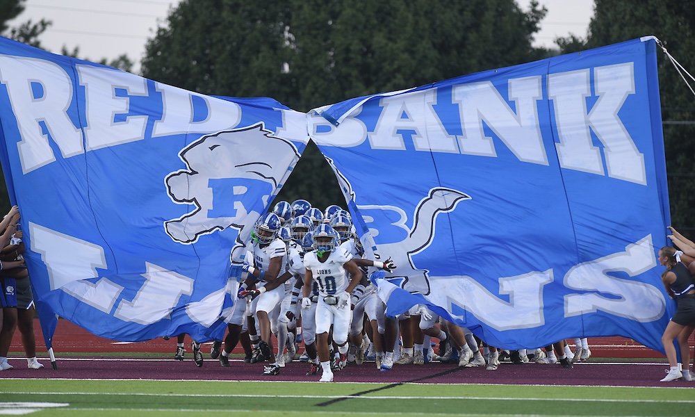 Staff photo by Matt Hamilton / The Red Bank team takes the field before the start of their game at Tyner Academy on Friday, Sept. 4, 2026.