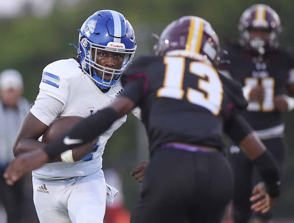 Staff photo by Matt Hamilton / Tyner (13) Kemarion Henderson defends as Red Bank (4) Austin Jones carries the ball during their game at Tyner Academy on Friday, Sept. 4, 2026.