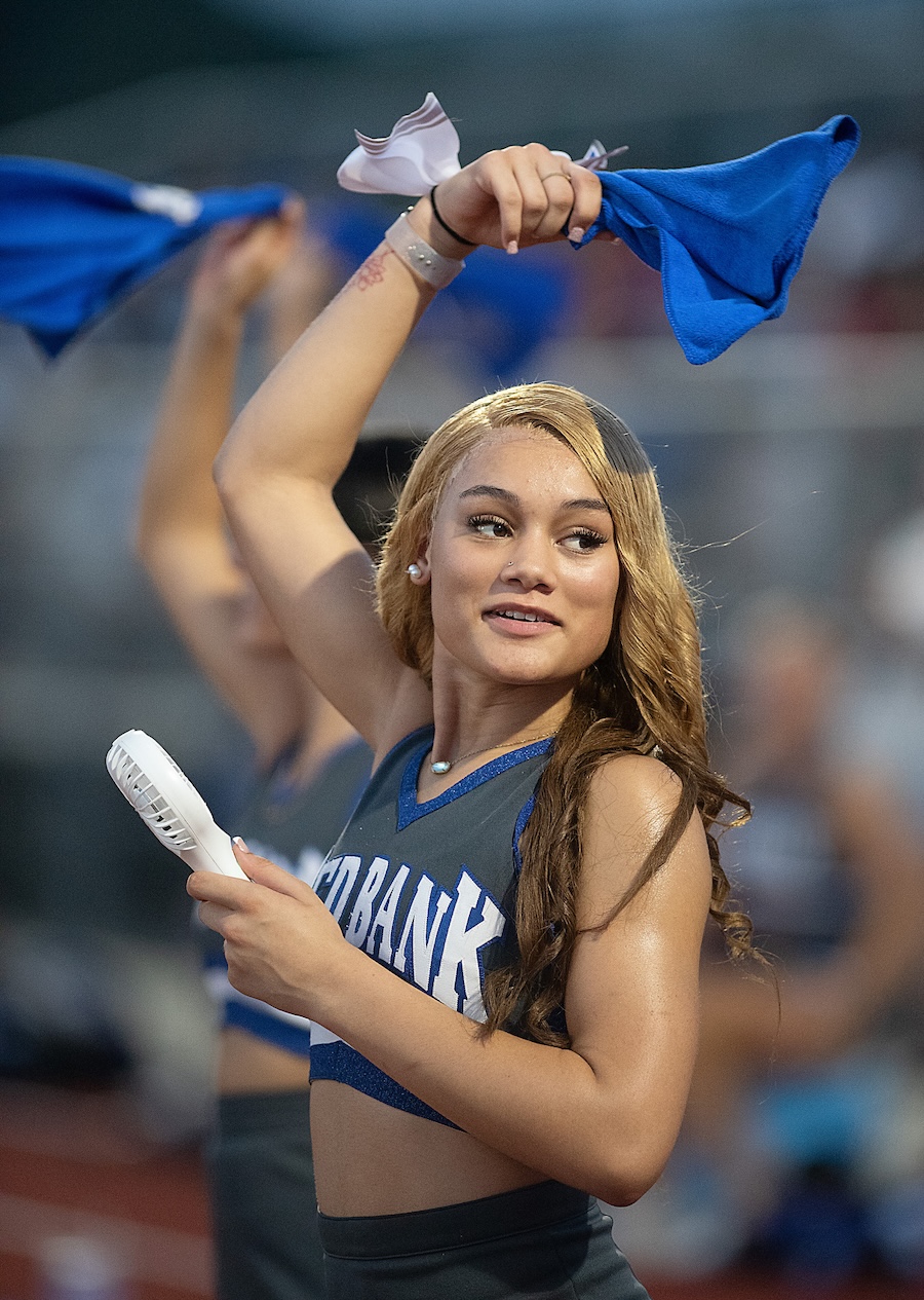 Staff photo by Matt Hamilton / Red Bank cheerleader Shylynn Collier, 17, waves a rally towel and uses a fan to keep cool during their game at Tyner Academy on Friday, Sept. 4, 2026.