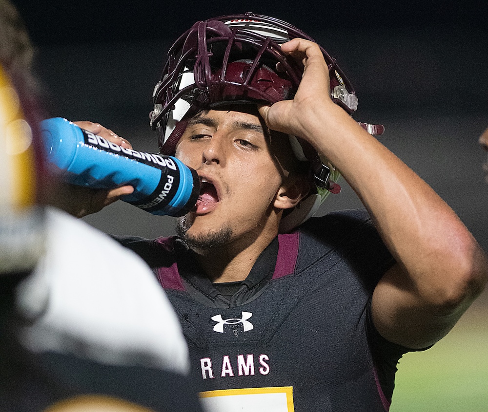 Staff photo by Matt Hamilton / Tyner (5) Tyson Sutton stays hydrated during their game against Red Bank at Tyner Academy on Friday, Sept. 4, 2026.