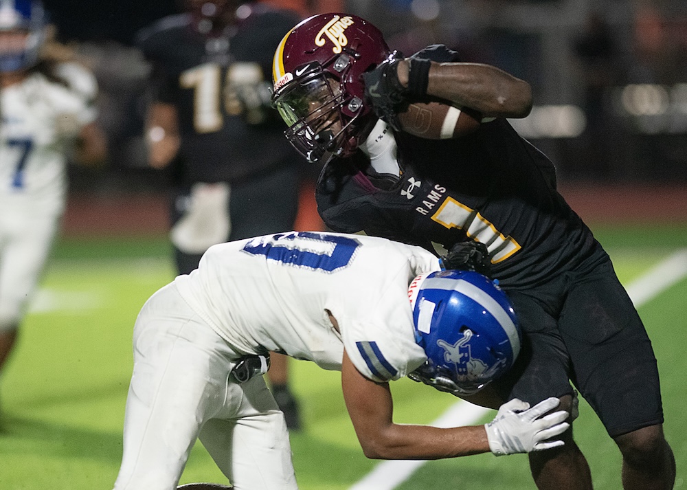 Staff photo by Matt Hamilton / Tyner (1) JD Hinton carries the ball as Red Bank (10) Shawn Carter defends during their game at Tyner Academy on Friday, Sept. 4, 2026.