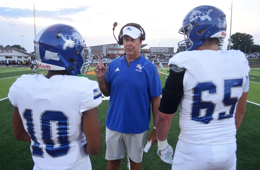 Staff photo by Matt Hamilton / Red Bank head coach Ted Gatewood talks to his captains about how to handle the coin toss before the start of their game at Tyner Academy on Friday, Sept. 4, 2026.
