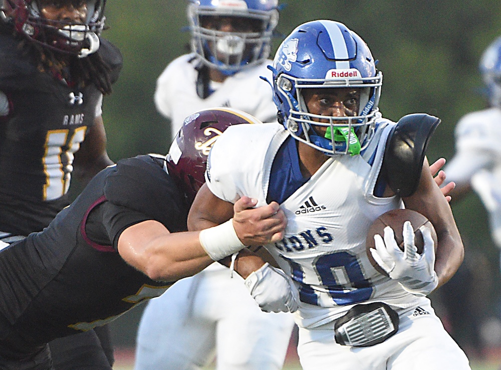 Staff photo by Matt Hamilton / Red Bank (10) Shawn Carter breaks a tackle as he carries the ball during their game at Tyner Academy on Friday, Sept. 4, 2026.