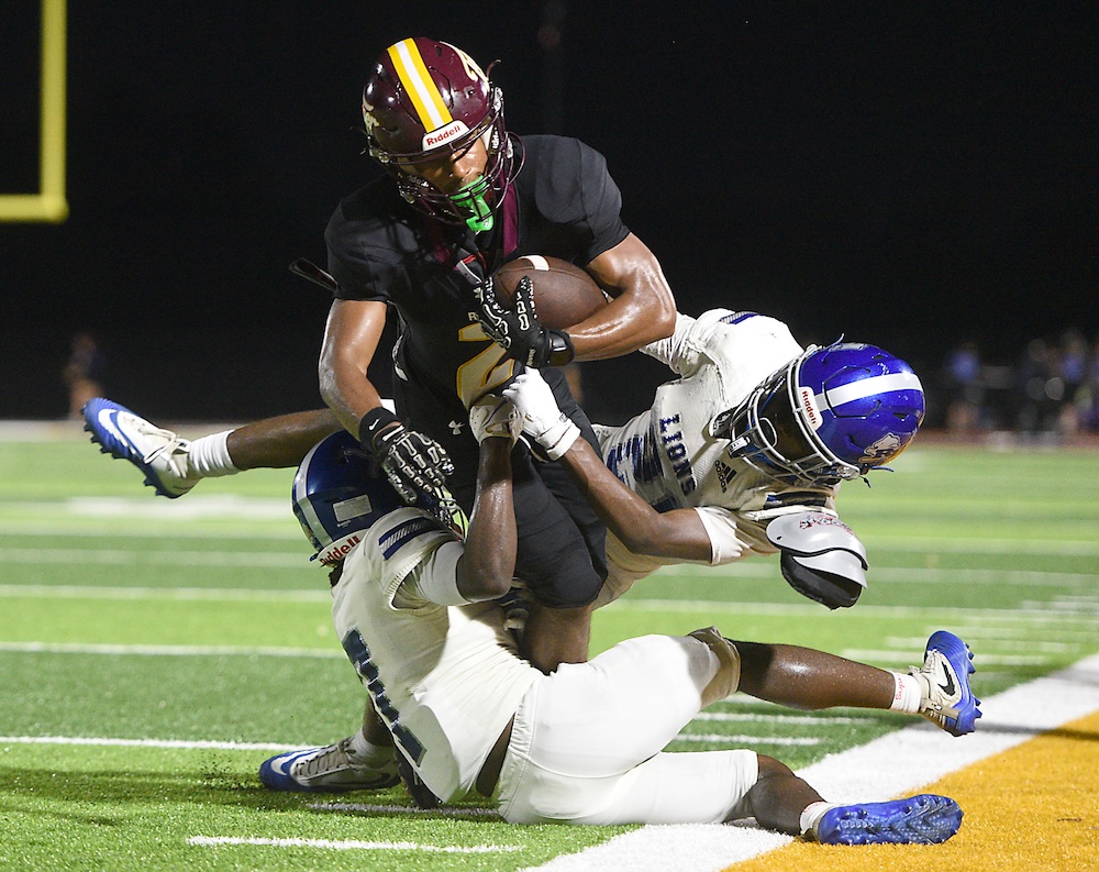 Staff photo by Matt Hamilton / Tyner (2) Karontae’ Cunningham hangs onto the ball as Red Bank (7) Ben Craig and (21) Arteries Chitty converge upon him during their game at Tyner Academy on Friday, Sept. 4, 2026.