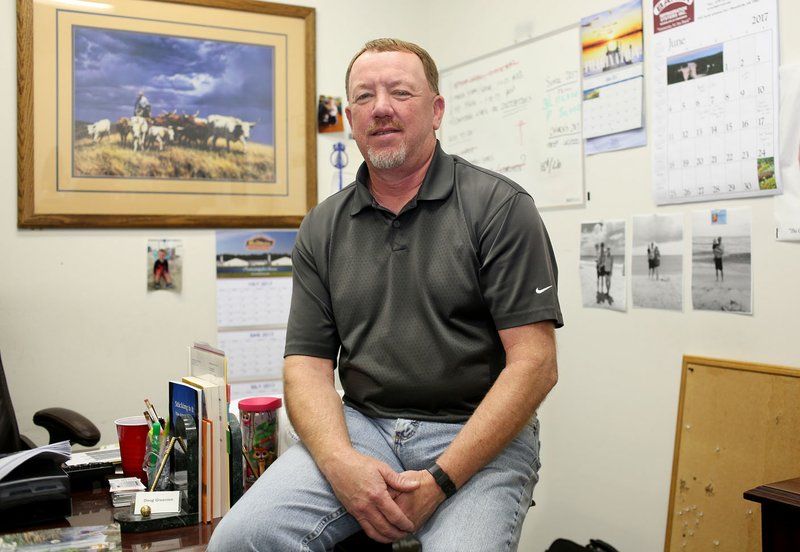 NWA Democrat-Gazette/DAVID GOTTSCHALK Doug Greenlee, former Springdale High quarterback who led the Bulldogs to a state championship in 1982, in his office at Twin Rivers Foods in Fayetteville.