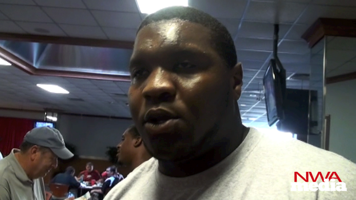 Arkansas guard Alvin Bailey speaks to reporters as the Razorbacks reported for preseason practice on Wednesday. 