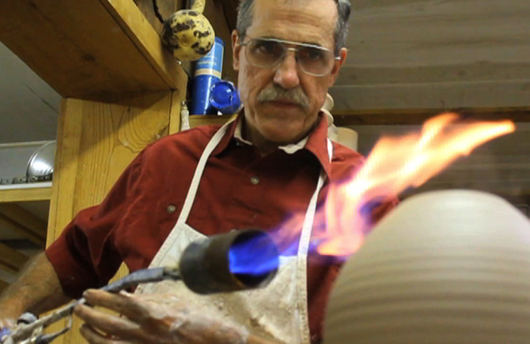 Potter Jim Larkin works in his Fox Pass Pottery studio in Hot Springs Tuesday
morning. He and his wife Barbara have been producing thrown and hand-built
pottery pieces at their studio since 1973.
