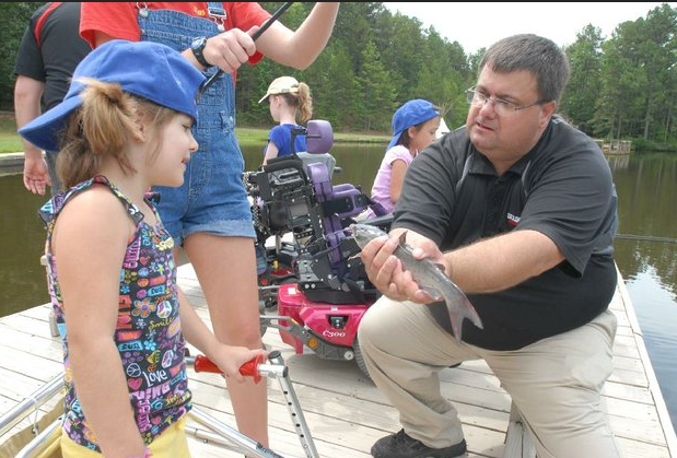 Children with special needs fished during a program Wednesday at Camp Aldersgate in Little Rock.