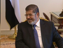 Egypt&#x27;s new president Mohammed Morsi has moved into Hosni Mubarak&#x27;s old office, starting the work of forming government.