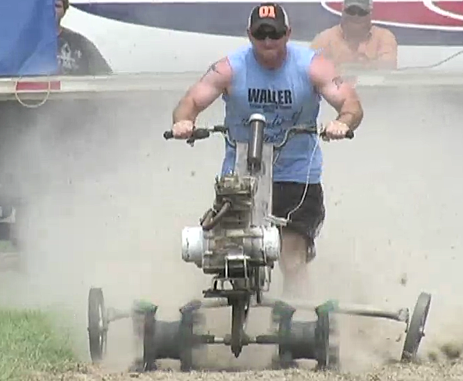 Huge plumes of dust shrouded racers as they ran at full speed along the dirt lanes. The crowd hooted as the tiller engines roared and belched smoke from their exhausts at the World Championship Rotary Tiller Race in Emerson, Ark.
