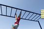 Alyssa Rodgers, 8, demonstrates the crucial role played by the legs for success on the North Little Rock riverfront&#x27;s new set of monkey bars. Music: Kevin MacLeod.