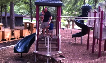 Paul Milholland plays with sons Winston, 4, and Jacob, eight months, during a visit to the park in Lakewood.
