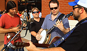 Members of the band Runaway Planet, Matthew Stone, Michael Proveaux, Steve
Brauer and Greg Alexander, sing outside Dickey-Stephens Park Friday evening
before the Arkansas Travelers&#x27; game.