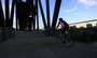 Bikers, walkers and runners cross the Clinton Presidential Park Bridge as the sun sets behind the clouds Monday evening over the Arkansas River.