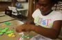 Jalisa and Aaron Barnes work on crafts at the Argenta Branch of the Laman Public Library System in North Little Rock on Friday. They are making soft picture frames.