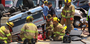 Little Rock firefighters stabilize an overturned truck as they and MEMS personnel work to remove an injured man Sunday afternoon after he collided with a church van at the intersection of Chicot Road and Baseline in Little Rock.
