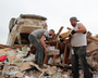 Tornado victims returned to their damaged and destroyed homes Tuesday in Vilonia, sifting through the wreckage for whatever could be salvaged.