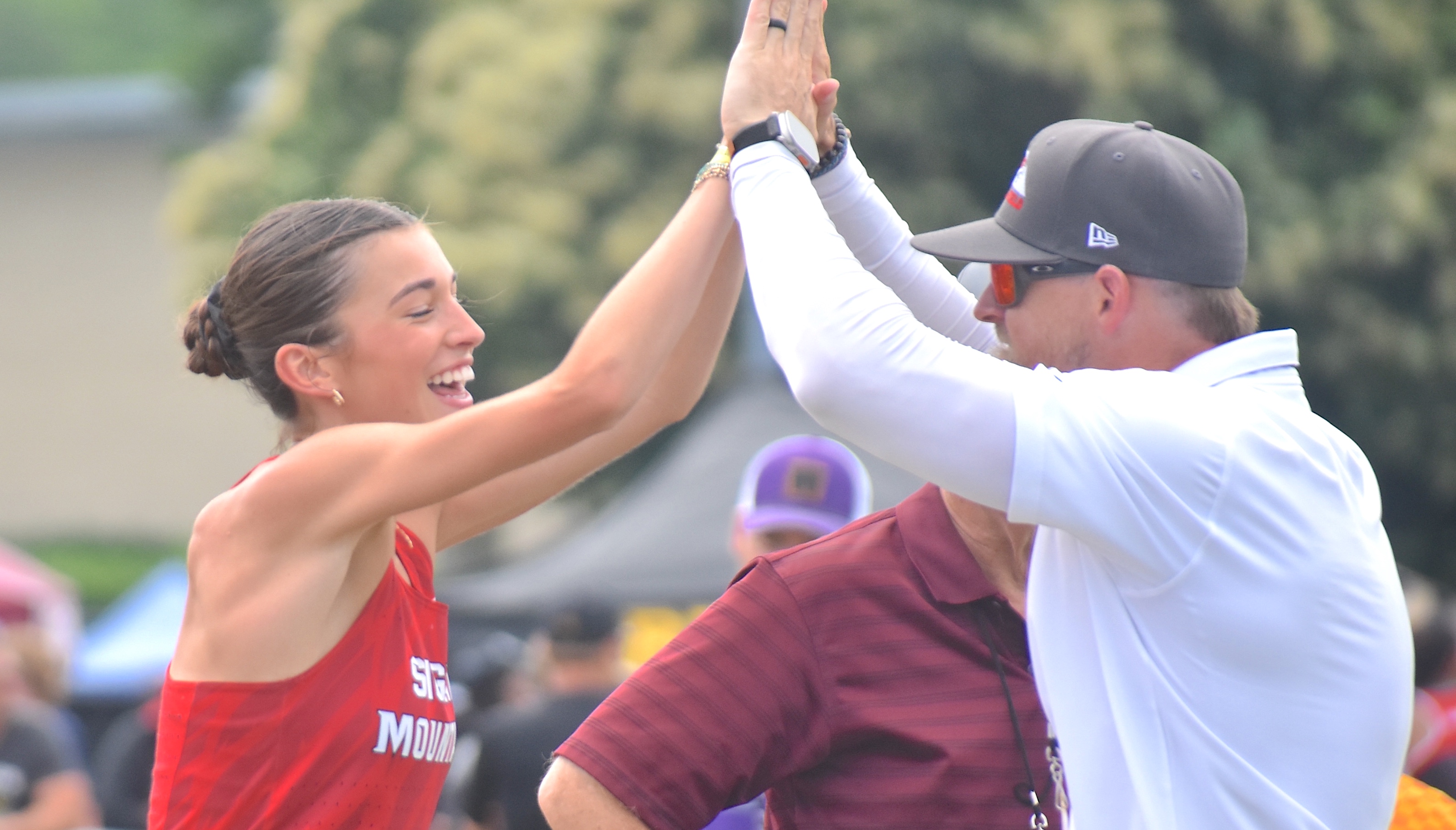 Staff photo by Patrick MacCoon / Signal Mountain junior Marlee Burkley celebrates her TSSAA Class AA state championship in the high jump with her assistant coach on the first day of the Spring Fling Tuesday in Murfreesboro.