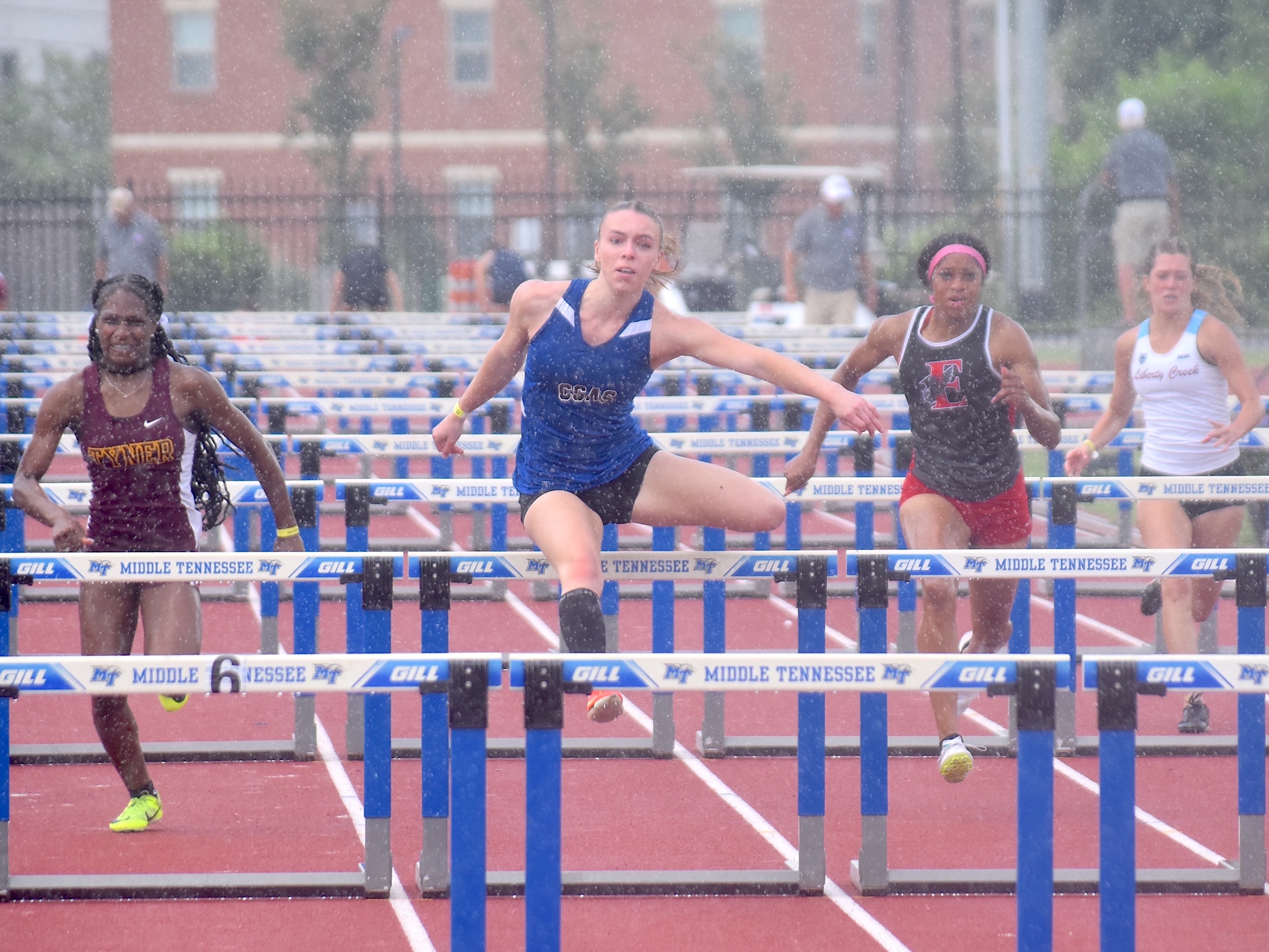Staff photo by Patrick MacCoon / Arts & Sciences' Fiona Eastman, center, wins a state title in the TSSAA Class A 100-meter hurdles on the first day of the Spring Fling Tuesday in Murfreesboro.