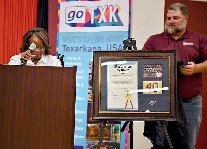 Chris Owens, Terry Roger's sister, and parks director Adam Dalby unveil a plaque honoring Terry Rogers during a ceremony renaming the Recreation Center, 1 Legion Drive, as the Terry Lee Rogers Recreation Center on Friday, May 30, 2025, in Texarkana, Ark. (Staff photo by Stevon Gamble)
