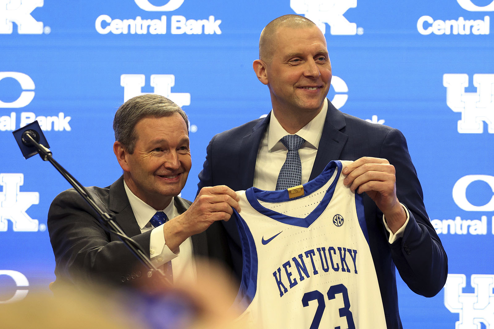 AP photo by James Crisp / Kentucky athletic director Mitch Barnhart, left, and basketball coach Mark Pope hold up a jersey at Pope's introductory news conference in Lexington on April 14, 2024.