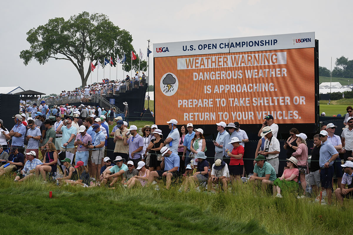 AP photo by Carolyn Kaster / Fans line the 18th green at Pennsylvania's Oakmont Country Club during the second round of the U.S. Open on Friday. More than a dozen golfers failed to finish when inclement weather arrived in the evening and will have to come back Saturday morning to complete their rounds.