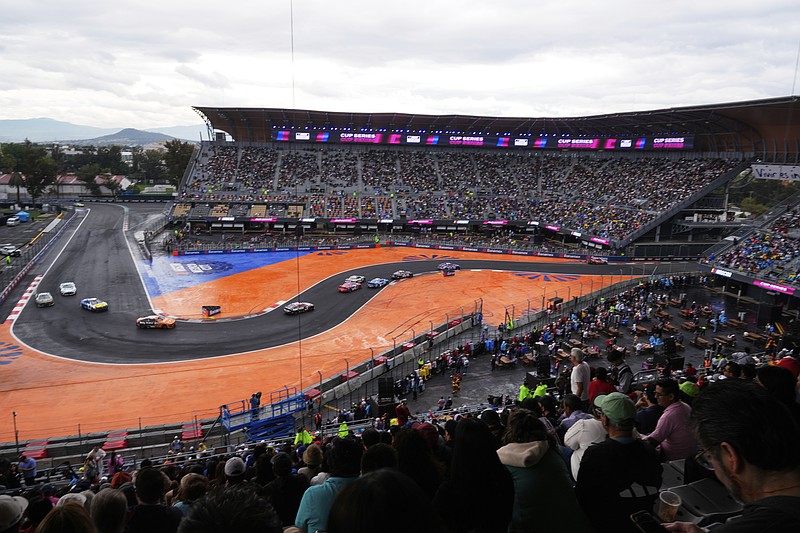Drivers battle for position during a NASCAR Cup Series auto race at Hermanos Rodríguez race track in Mexico City, Sunday, June 15, 2025. (AP Photo/Marco Ugarte)