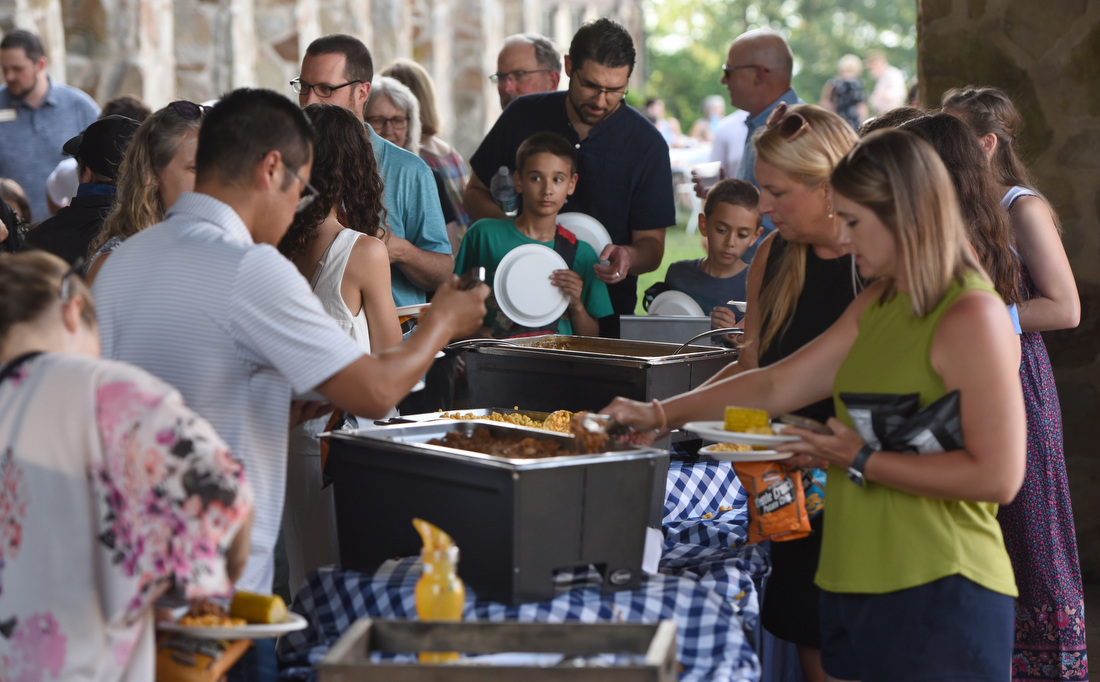 Staff photo by Matt Hamilton / Guests serve themselves dinner June 25, 2025, during an outdoor picnic at Covenant College in Lookout Mountain, Ga.