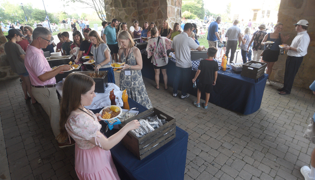 Staff photo by Matt Hamilton/ Guests serve themselves dinner June 25, 2025, during an outdoor picnic at Covenant College in Lookout Mountain, Ga.