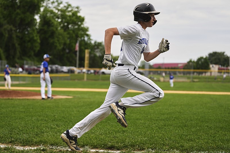 Jax Casamento, 15, runs to first base during his youth baseball game May 27, 2025, in Aston, Pa. (AP Photo/Matt Rourke)
