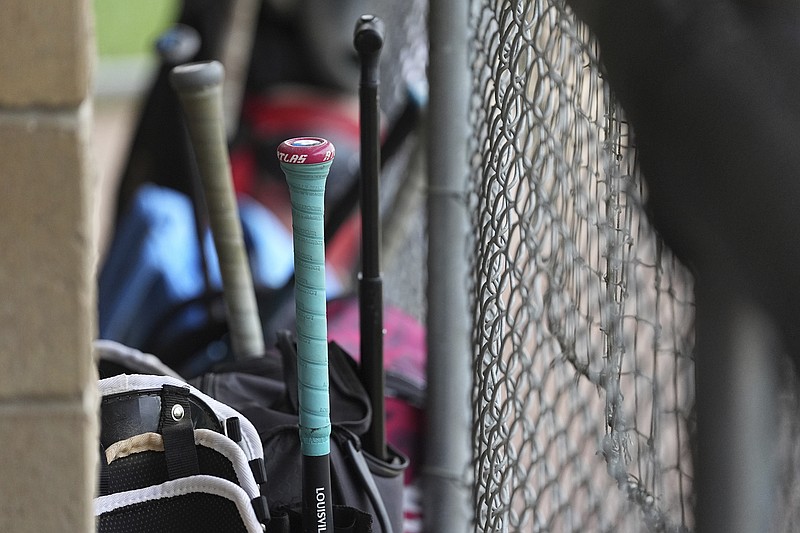 Sports equipment lines the dugout ahead of a youth baseball game May 27, 2025, in Aston, Pa. (AP Photo/Matt Rourke)
