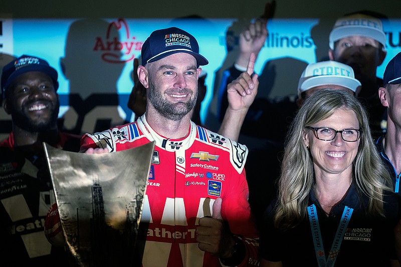 AP photo by Erin Hooley / Trackhouse Racing driver Shane van Gisbergen, center, stands with NASCAR Chicago Street Course president Julie Giese after winning Sunday's Cup Series race.