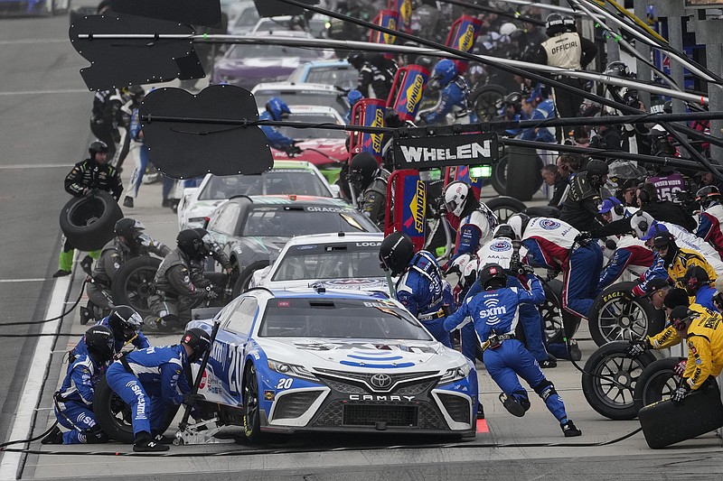 AP photo by Jae C. Hong / Pit crews work during a NASCAR Cup Series race at Auto Club Speedway on Feb. 26, 2023, in Fontana, Calif. The Cup Series will return to Southern California for a regular-season race for the first time since then with next year's event on a street course at Naval Base Coronado.