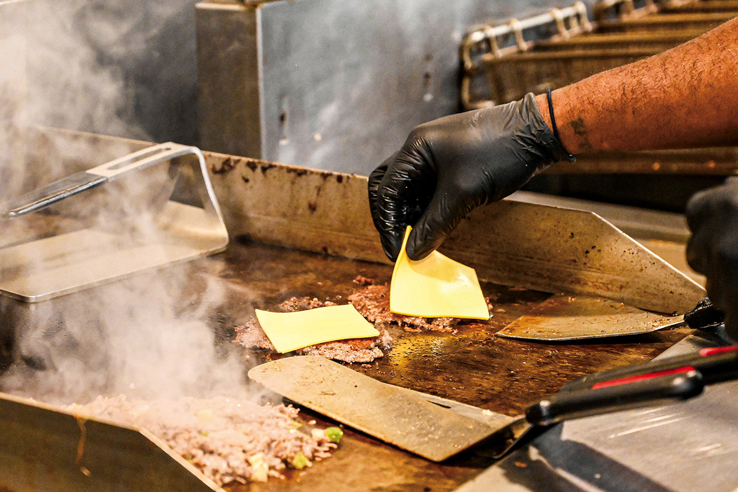 Staff photo by Abby White / Chef Terrence Locke grills a smash burger at Chef Express, a local catering business.