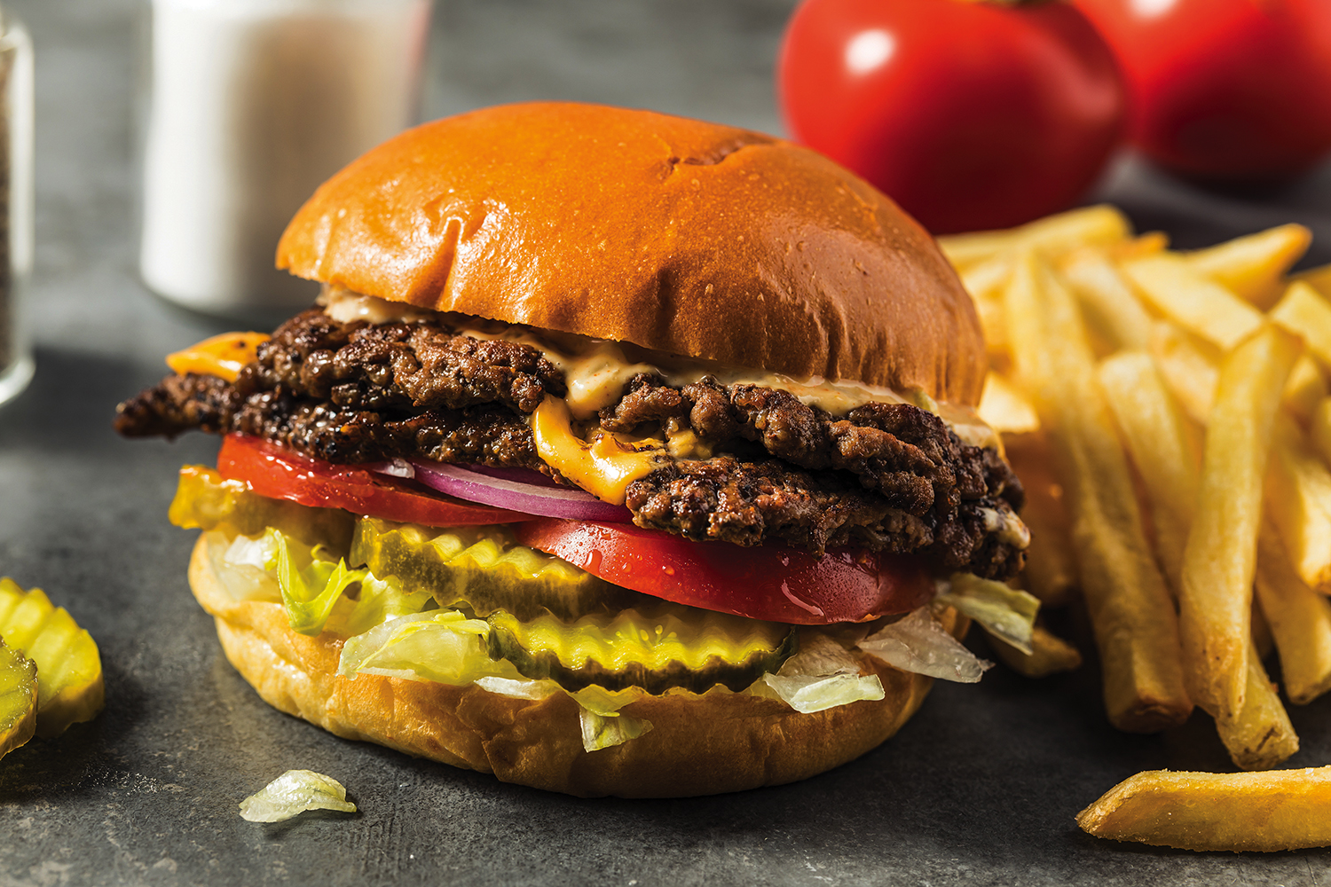 Getty Images / A homemade double smash burger with cheese and all the toppings