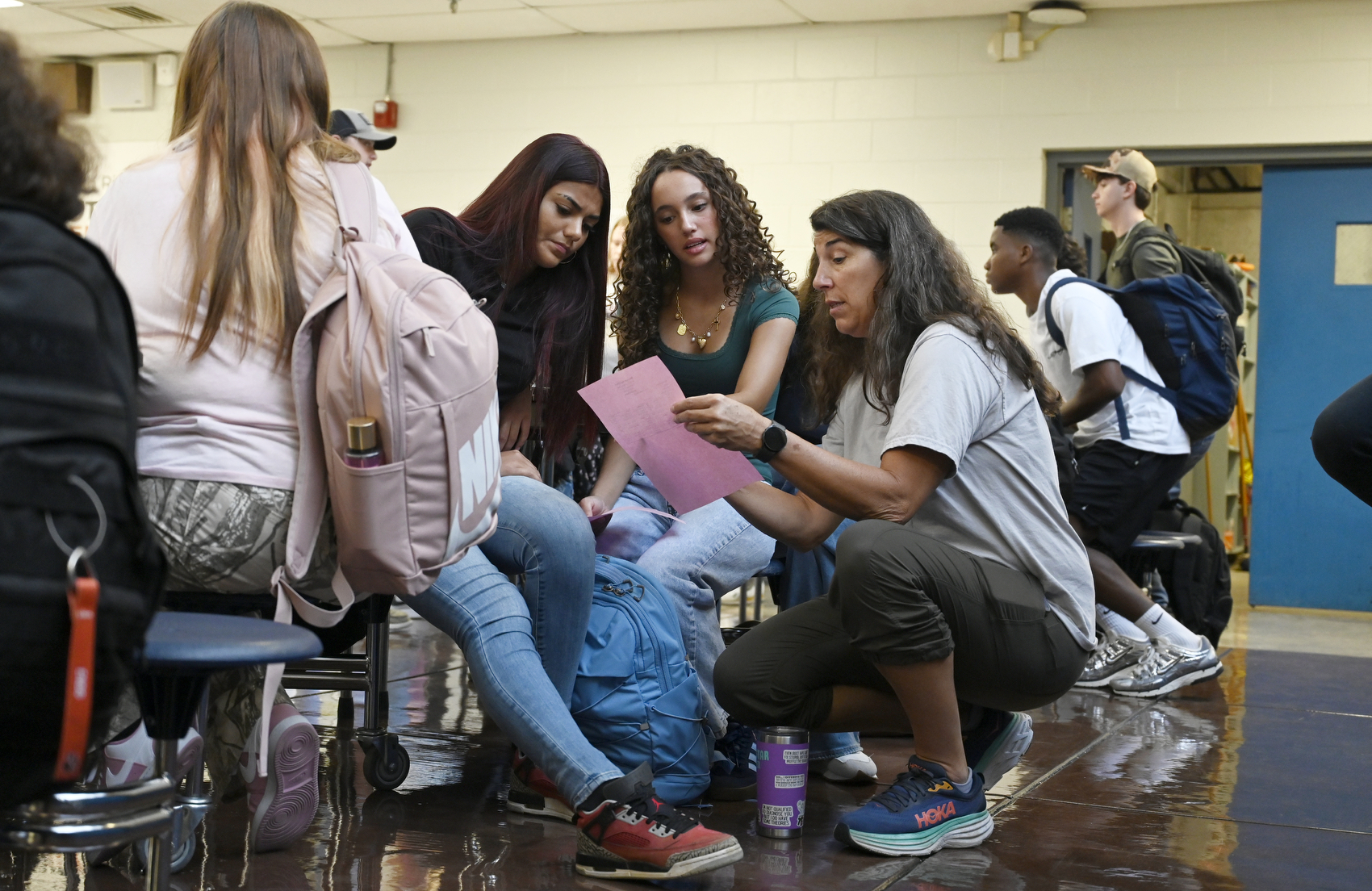 Staff photo by Abby White / Brooke Laxton, right, explains the school schedule to a gaggle of freshmen. North River Future Ready Center, formerly Sequoyah High School, held its first day of classes Aug. 6, 2025, and became the second campus in Hamilton County to become a centralized hub for career and technical education.