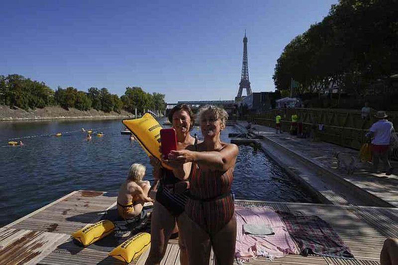 Women take a selfie after a swim in the Seine river, Monday, Aug. 11, 2025 in Paris. (AP Photo/Aurelien Morissard)