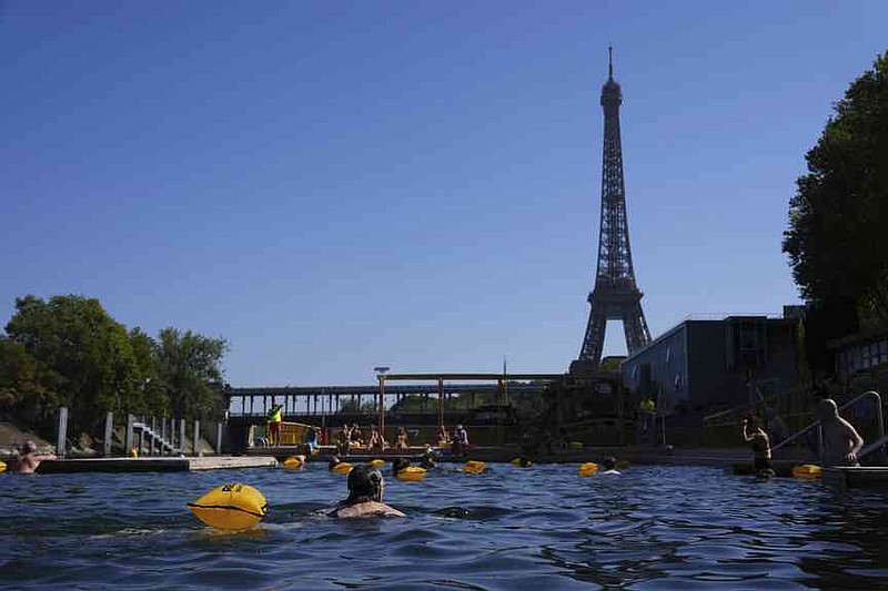 People swim in the Seine river, Monday, Aug. 11, 2025 in Paris. (AP Photo/Aurelien Morissard)