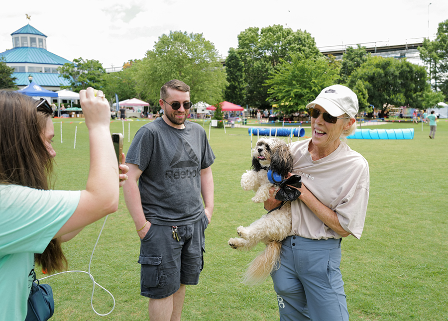 Photo by Mark Gilliland / Olivia Smith takes a photo of Jacob Moller and Charlie & Donna Griswold.