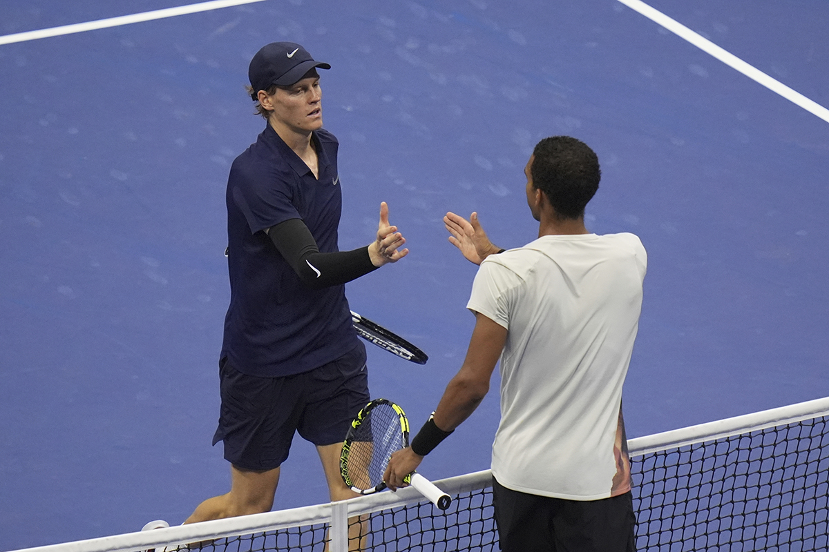 AP photo by Seth Wenig / Jannik Sinner, left, greets Felix Auger-Aliassime at the net after their U.S. Open men's singles semifinal Friday night in New York. Sinner won 6-1, 3-6, 6-3, 6-4.
