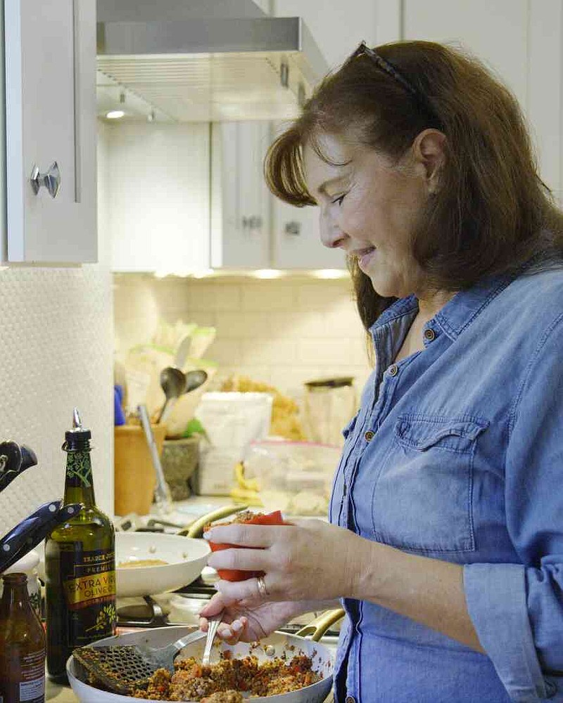 Dominique Debroux prepares a meal at home in Cliffside Park, N.J., on Sept. 11, 2025. (Dominique Debroux via AP)
