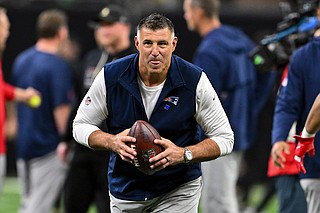 AP photo by Maria Lysaker / New England Patriots head coach Mike Vrabel plays catch with players as they warm up for last Sunday's road game against the New Orleans Saints.