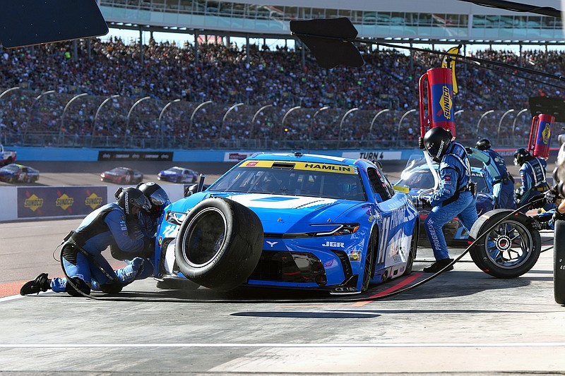 AP photo by Rick Scuteri / Denny Hamlin 's crew works on his Joe Gibbs Racing No. 11 Toyota in the pits during Sunday's NASCAR Cup Series season finale at Phoenix Raceway in Avondale, Ariz.