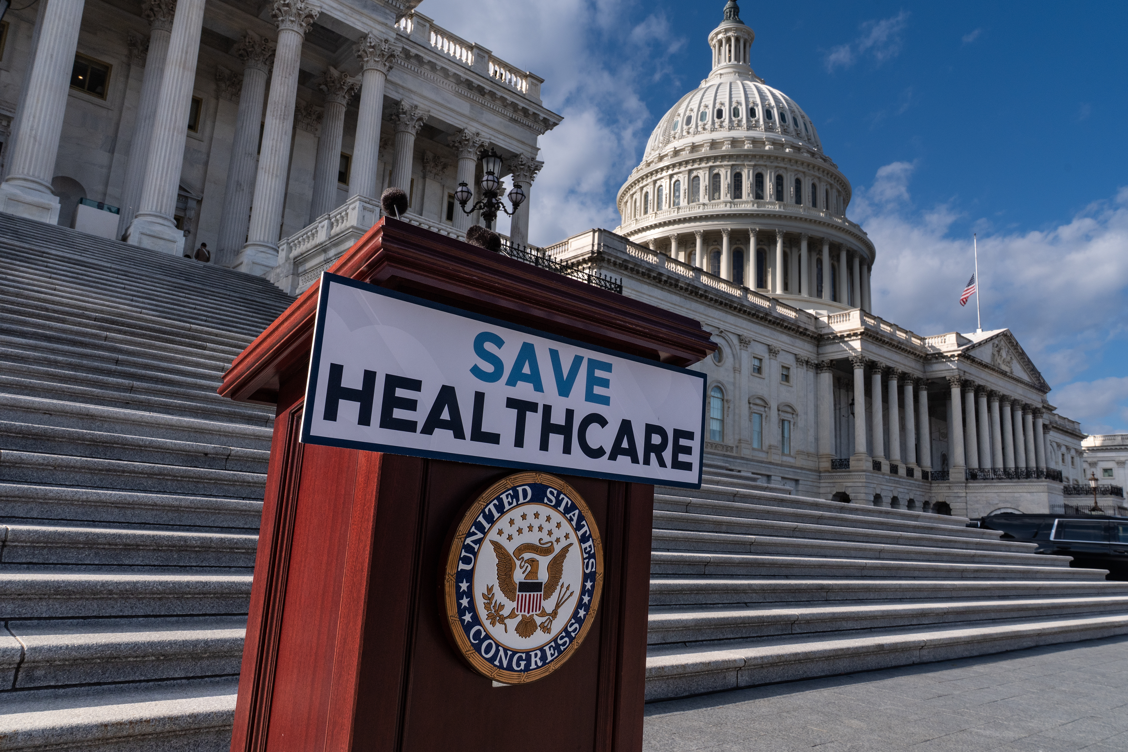 A lectern awaits the arrival of House Democrats to speak on the health care funding fight on the steps of the House before votes to end the government shutdown, at the Capitol in Washington, Wednesday, Nov. 12, 2025. (AP Photo/J. Scott Applewhite)