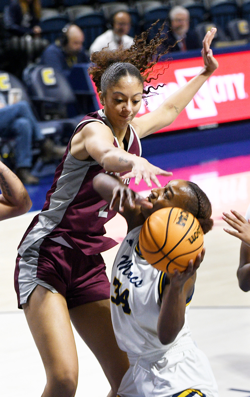 Staff Photo by Robin Rudd / Bellarmine's Andrea Chiquemba (14) causes UTC's Kalifa Ford (34) to miss her shot. The University of Tennessee at Chattanooga Mocs hosted the Bellarmine Knights in a NCAA basketball game, at McKenzie Arena, on Dec. 7, 2025.