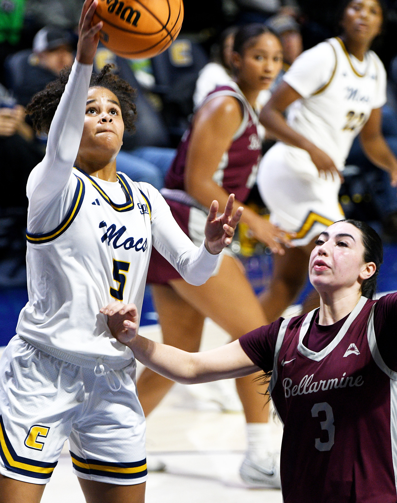 Staff Photo by Robin Rudd / UTC's Sarah Owona (5) drives to the basket against Bellarmine's Ava Smith (3). The University of Tennessee at Chattanooga Mocs hosted the Bellarmine Knights in a NCAA basketball game, at McKenzie Arena, on Dec. 7, 2025.