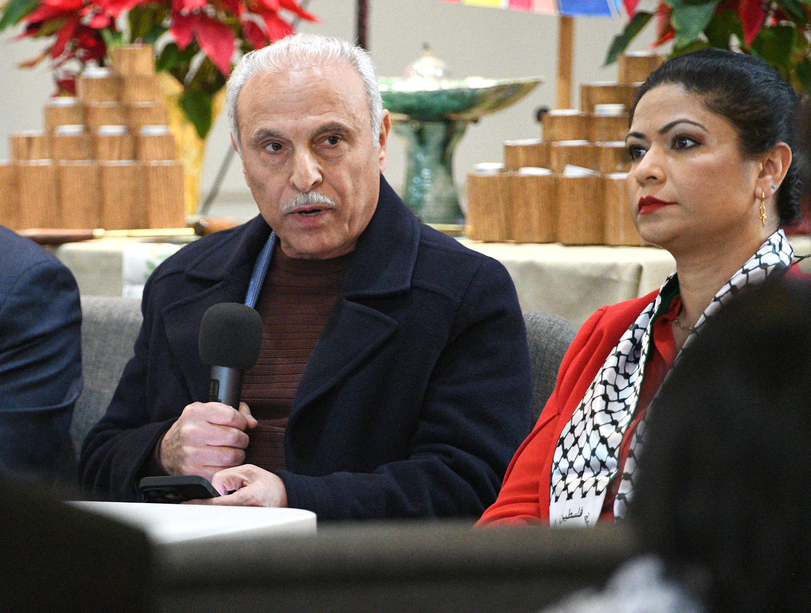 Staff Photo by Robin Rudd / Bassam Issa, local human rights advocate, left, speaks as fellow panelist Amna Shah listens during a Human Rights Day event at the Unitarian Universalist Church.
