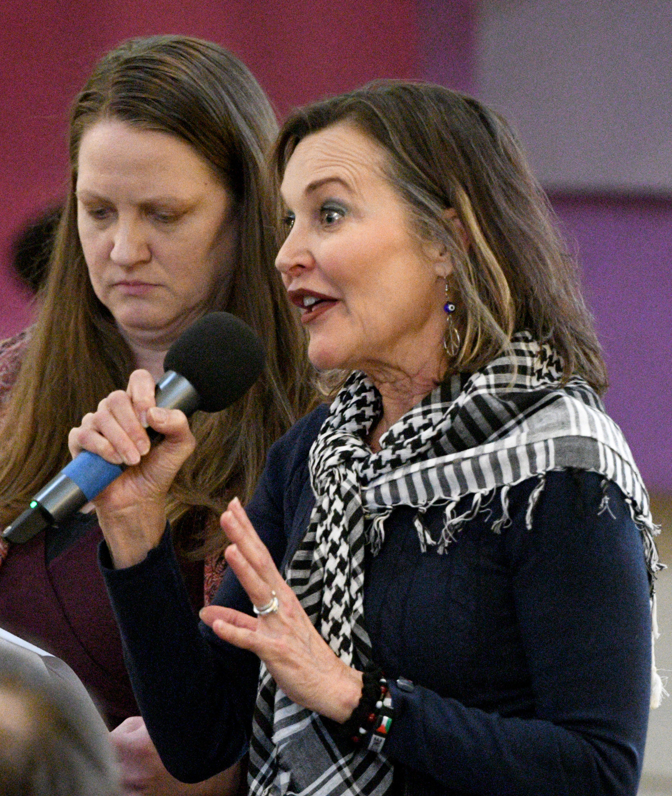 Staff Photo by Robin Rudd / Missy Crutchfield, cofounder of Be Magazine and director of the Gandhi Global Center for Peace, right, speaks as moderator Melissa Turner listens during a Human Rights Day event at the Unitarian Universalist Church.